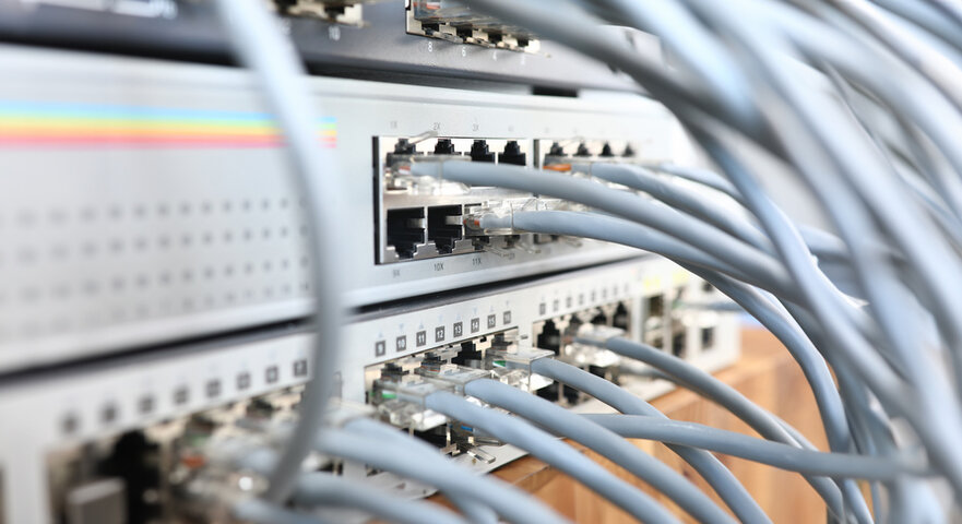 Close-up view of several network cables plugged into ports on a network switch or server, illustrating a data center or IT infrastructure environment.